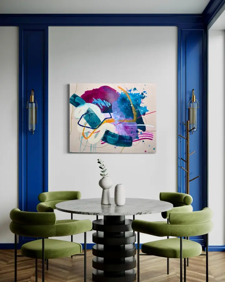 The Shape of Healing hung in a dining room with blue trim and green chairs